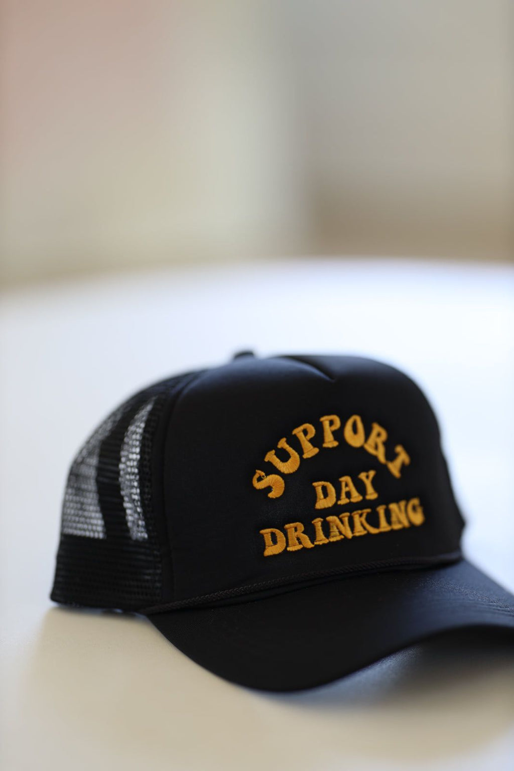 HAZEL & OLIVE Support Day Drinking Embroidered Trucker Hat - Black